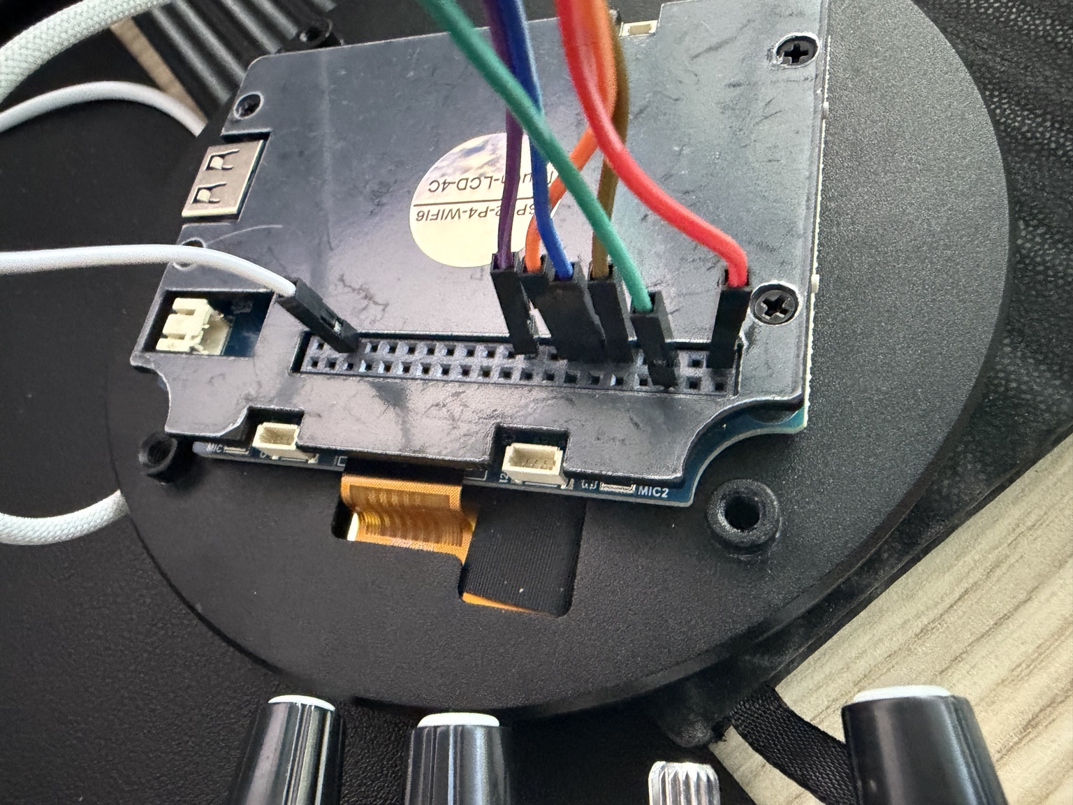 Rear of the round display connected with prototype jumper wires