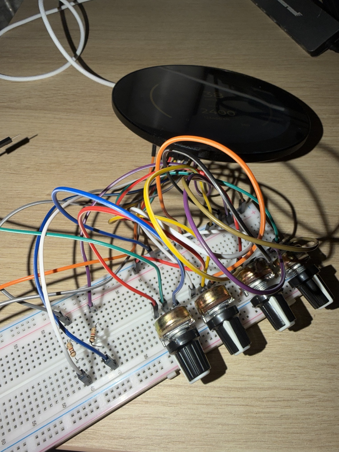 Round display connected to a breadboard wiring prototype