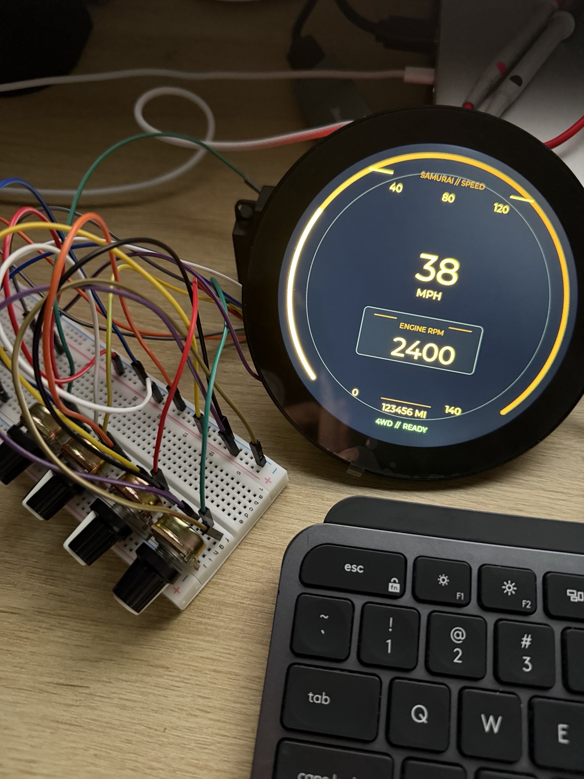 Round digital gauge running a warm amber speed and RPM interface